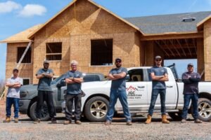 JGC Construction team in front of a home build
