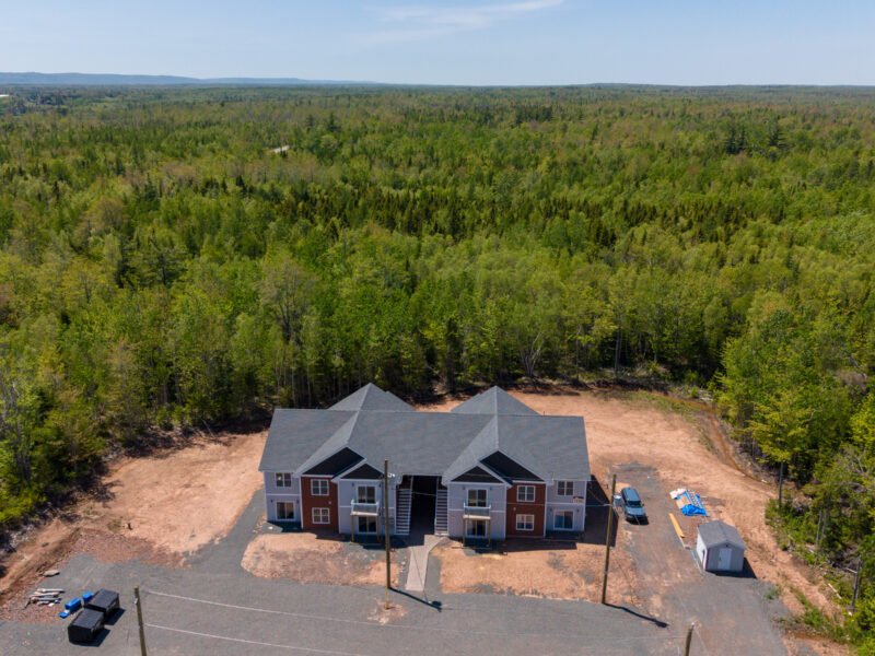 Finished Creamery Landing apartment building set against forest in Tatamagouche, NS