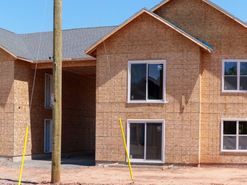 Sheathed two-storey multi-unit building with a covered breezeway at Creamery Landing, Tatamagouche