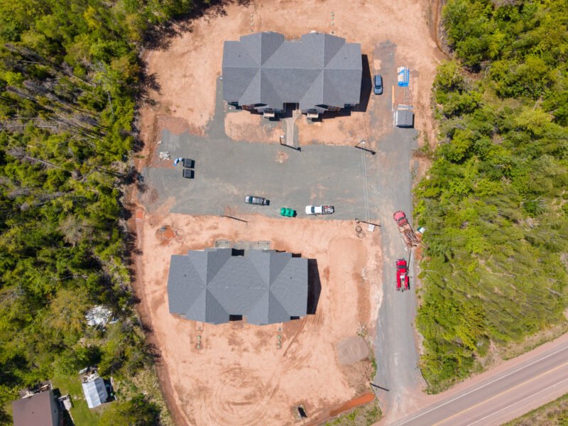 Overhead drone photo of two multi-unit buildings and parking at Creamery Landing, Tatamagouche