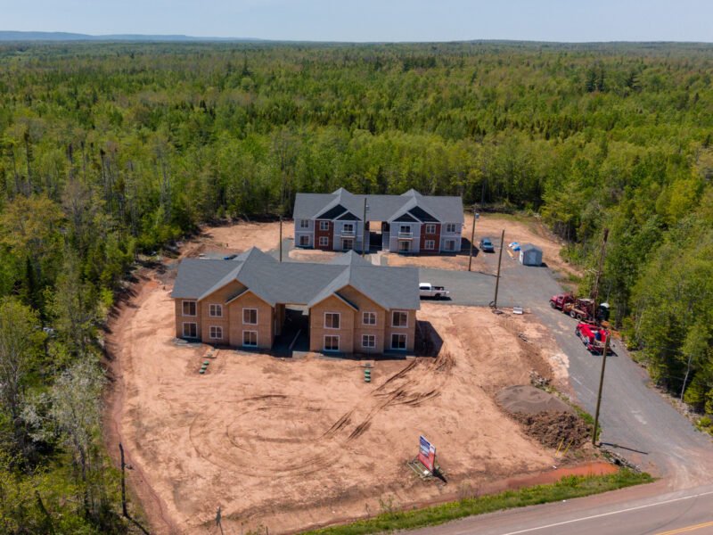 Sheathed multi-unit building and paved lot at Creamery Landing in Tatamagouche, Nova Scotia