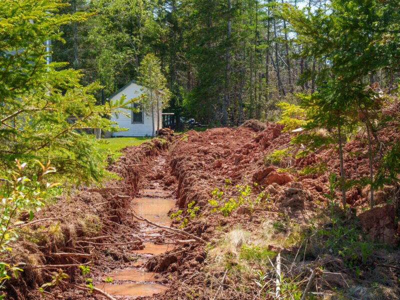 Trench through red clay soil on the East Mountain building lot