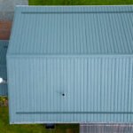Overhead drone view of a teal-green metal roof on a home in Lower Harmony, near Truro NS