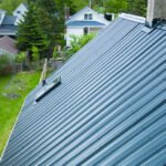 Dark metal roof with a skylight and chimney flashing on a home in Truro, NS