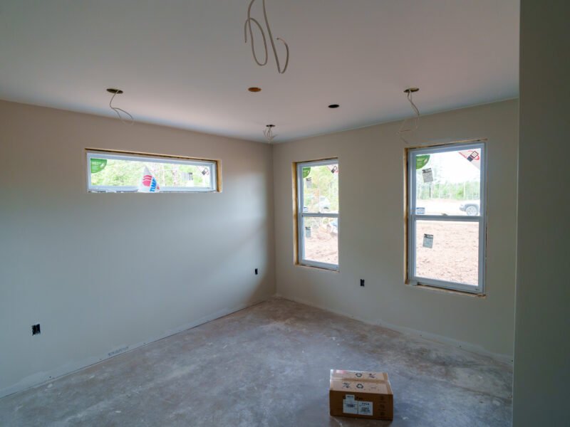 Bedroom with transom and double-hung windows in a new East Mountain home