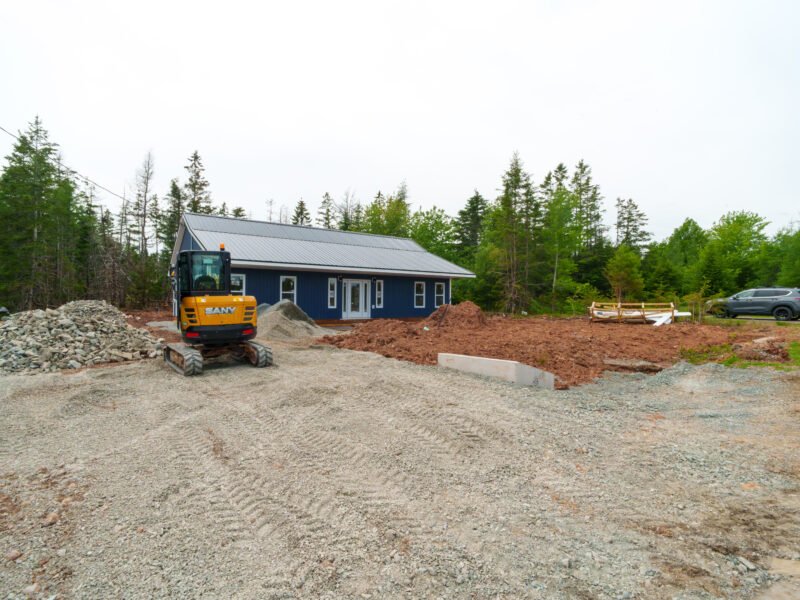 Mini excavator and gravel pad in front of a new home in East Mountain, Nova Scotia