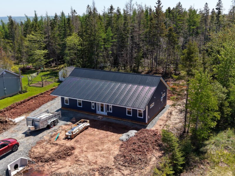 Drone view of a new home build and gravel driveway in East Mountain, near Truro