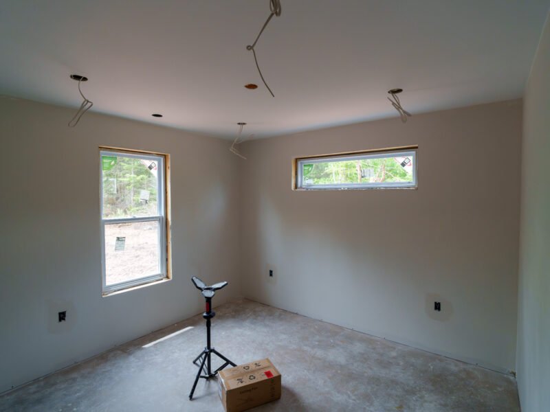 Second bedroom with a transom window at the drywall stage in East Mountain, NS