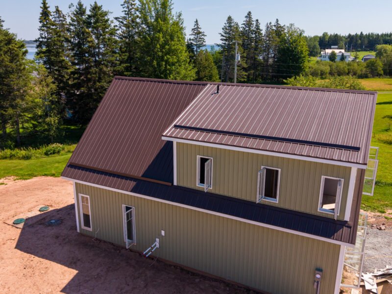 Shed dormer and brown steel roof on a storey-and-a-half home in Bayhead, NS