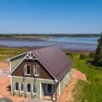 New waterfront home with a brown steel roof overlooking Tatamagouche Bay in Bayhead, NS
